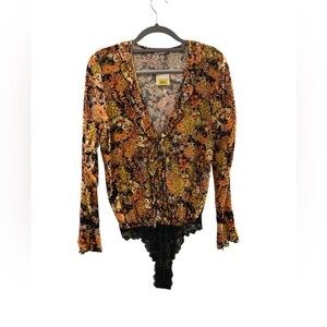 Free people NEW medium heat wave floral bodysuit with ruffle details.